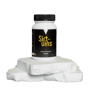 A bottle of sift-uins on top of some white rocks.