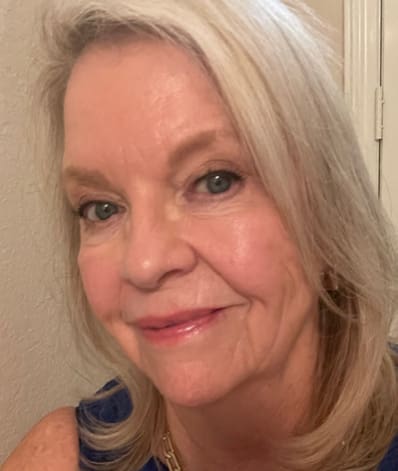 A woman with blonde hair and blue eyes.