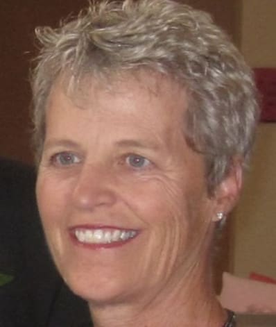 A woman with short hair smiles for the camera.