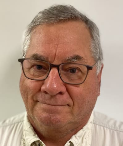 A man with glasses and a white shirt