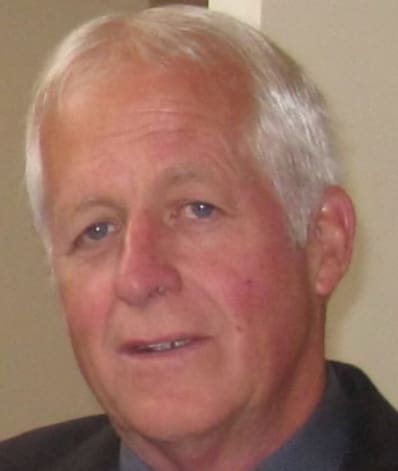 A man with white hair and blue eyes.