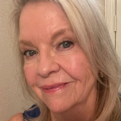 A woman with blonde hair and blue eyes.