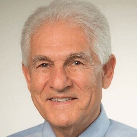 Smiling older man in blue collared shirt